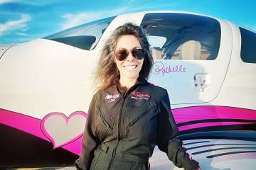 Rachelle Hart, founder of I Hart Flying Foundation next to her pink and black Cirrus