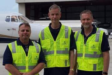Crew Chiefs company founders in hi-vis vests in front of business aircraft