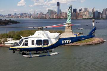 Bell 412EP operated by NYPD in flight over the Hudson River with the Statue of Liberty in the background