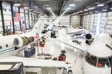 ACI Jet maintenance hangar with maintenance being performed on several business jets and turboprops